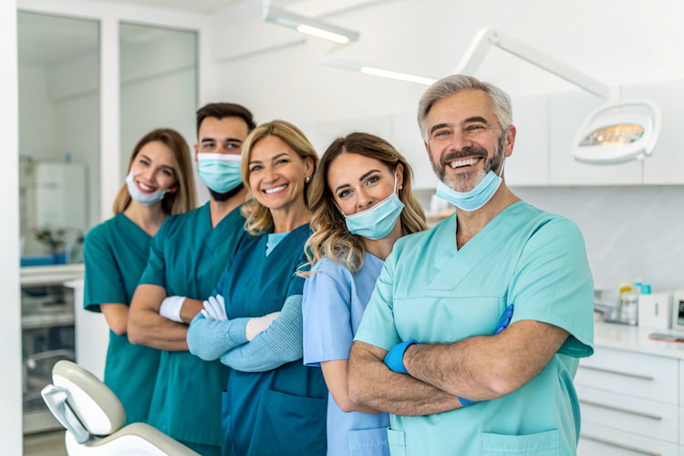 a dental team offering dental services such as removing all natural teeth and dentures 