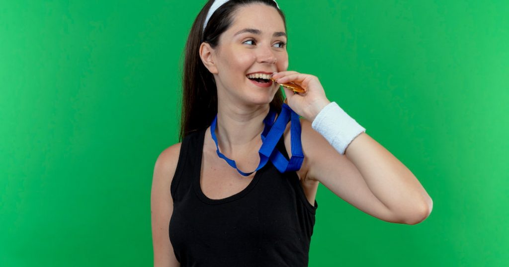 a photo of a woman wearing a mouthguard playing sports with braces