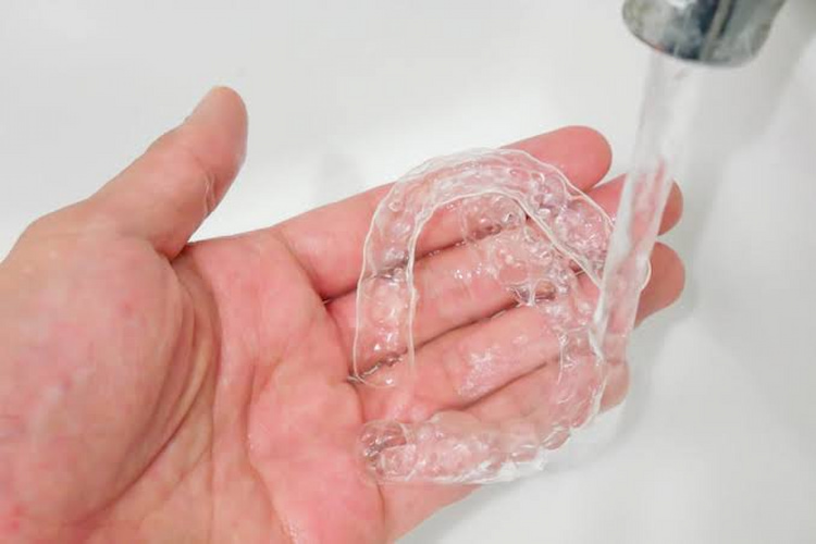 a photo showing how to maintain Invisalign aligners