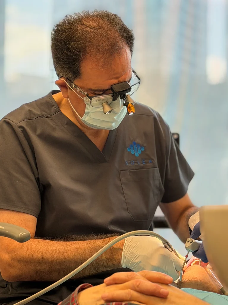 Dr. Golabchifar while performing the dental treatment